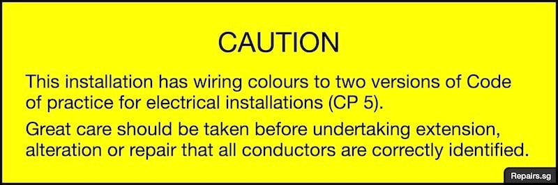 Image of warning notice to inform individuals that there are two versions of cable colour codes used in an electrical installation.